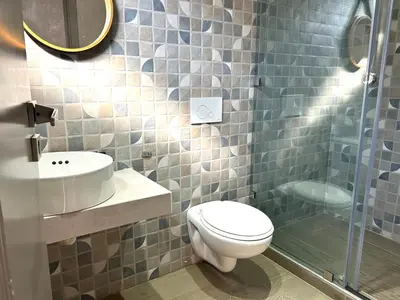 a bathroom with a toilet and a sink and a shower at Villa Naouma in Marrakech