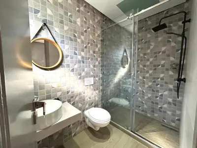 a bathroom with a toilet and a glass shower at Villa Naouma in Marrakech
