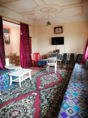 a living room with a couch and a table at Maison d'hôtes au pied du grand Atlas- Asguine- Ourika in Asguine