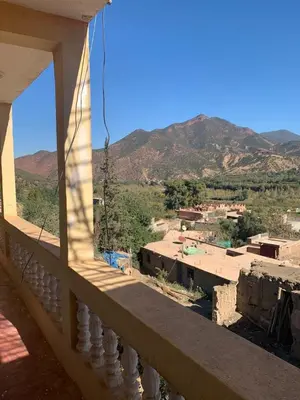 a view of a city from a balcony of a building at Maison d'hôtes au pied du grand Atlas- Asguine- Ourika in Asguine