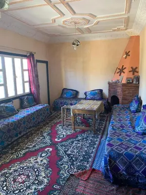 a room with a couch and a table in a room at Maison d'hôtes au pied du grand Atlas- Asguine- Ourika in Asguine
