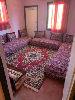 a living room with a couch and a rug at Maison d'hôtes au pied du grand Atlas- Asguine- Ourika in Asguine