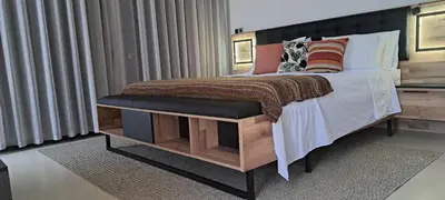 a bedroom with a bed with a black foot board at Villa Deluxe Au Pied de l'Atlas Béni Mellal in Ksar et Tlatia