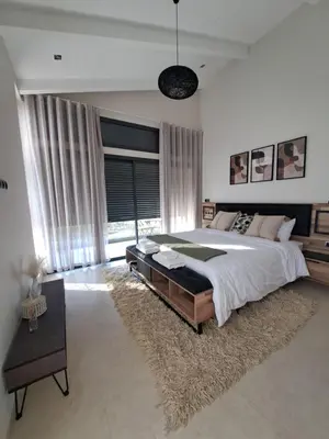 a large bedroom with a large bed and a large window at Villa Deluxe Au Pied de l'Atlas Béni Mellal in Ksar et Tlatia