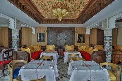a dining room with tables and chairs and a ceiling at DARIF's Riad & Spa in Fès