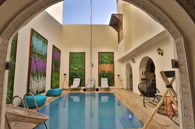 an indoor pool in a house with an archway at DARIF's Riad & Spa in Fès