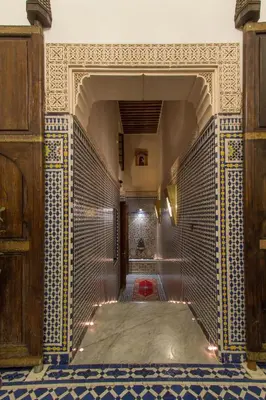 a hallway with a tile wall in a building at Riad Al Makan Fes & Spa in Fès