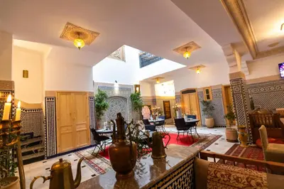 a large living room with tables and chairs at Riad Al Makan Fes & Spa in Fès