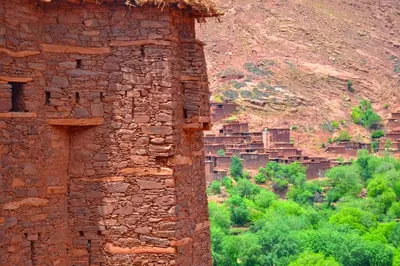 an old stone building with a mountain in the background at Dar Megdaz in Megdaz