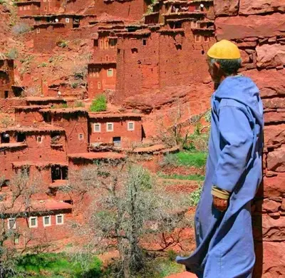 a man walking in front of a canyon at Dar Megdaz in Megdaz