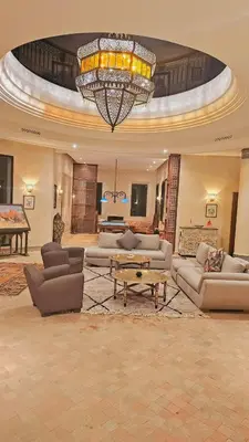 a large living room with couches and a chandelier at villa blanche Marrakech in Marrakech