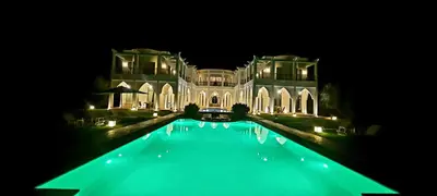 a large house with a swimming pool at night at villa blanche Marrakech in Marrakech