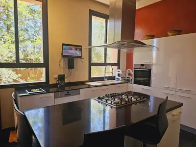a kitchen with a counter with a stove top at villa blanche Marrakech in Marrakech