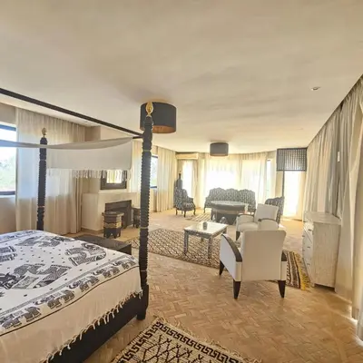 a bedroom with a bed and a living room at villa blanche Marrakech in Marrakech