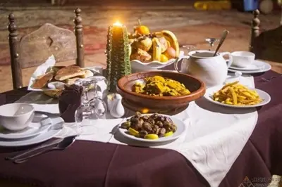 a table with plates of food on a table at Merzouga Luxury Tent in Merzouga