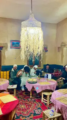 a group of people sitting in a living room at Kasbah Citoyenne in Agoudal