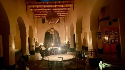 a man standing in the middle of a room with a table at Kasbah Citoyenne in Agoudal