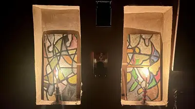 two doors with stained glass on them in a room at Kasbah Citoyenne in Agoudal