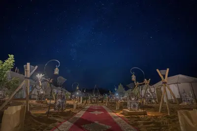 a starry night view of a wedding venue with a red carpet at Sanmao Royal Camp \u7687\u5bb6\u8425\u5730 in Merzouga