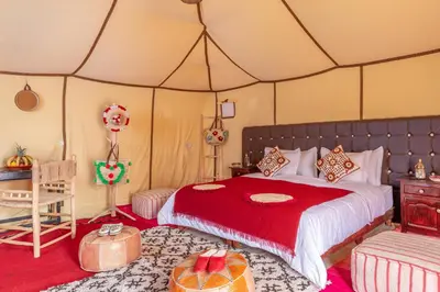 a bedroom with a bed in a tent at Sanmao Royal Camp \u7687\u5bb6\u8425\u5730 in Merzouga