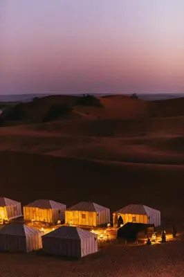 a group of tents in the desert at night at Sanmao Royal Camp \u7687\u5bb6\u8425\u5730 in Merzouga
