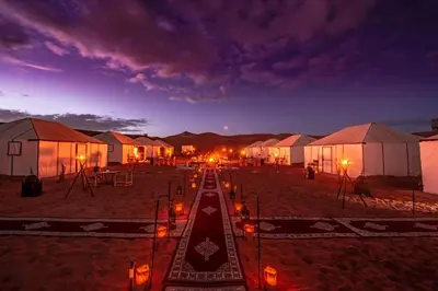 a row of tents in the desert at night at Sanmao Royal Camp \u7687\u5bb6\u8425\u5730 in Merzouga