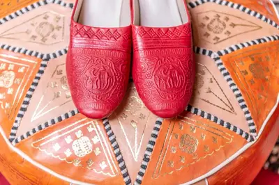 a pair of red shoes sitting on top of a bowl at Sanmao Royal Camp \u7687\u5bb6\u8425\u5730 in Merzouga