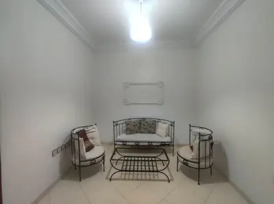 a white room with three chairs and a couch at SkyRise Khemisset 2 : 2 bedrooms in Khemisset