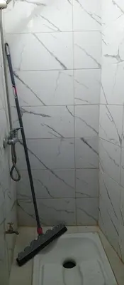 a mop in a corner of a bathroom with a toilet at Moulay Idriss in Moulay Idriss Zerhoun