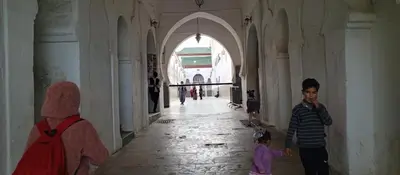 a man and a child standing in a hallway at Moulay Idriss in Moulay Idriss Zerhoun