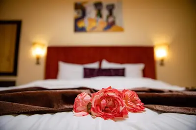 a flower on top of a bed in a bedroom at ROYAL GOLF DE FES in Fès