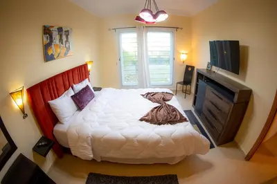 a bedroom with a large white bed and a television at ROYAL GOLF DE FES in Fès