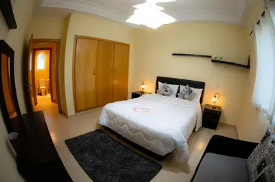 a bedroom with a large white bed in a room at ROYAL GOLF DE FES in Fès