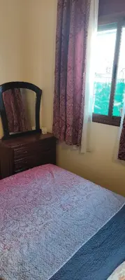 a bedroom with a bed and a window at DAR LAAZIZA in Meknès