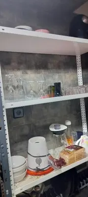 a shelf filled with glasses and plates and bowls at DAR LAAZIZA in Meknès
