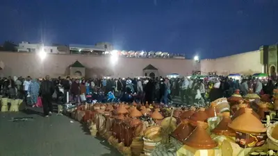 a group of people standing around a group of fire hydrants at DAR LAAZIZA in Meknès