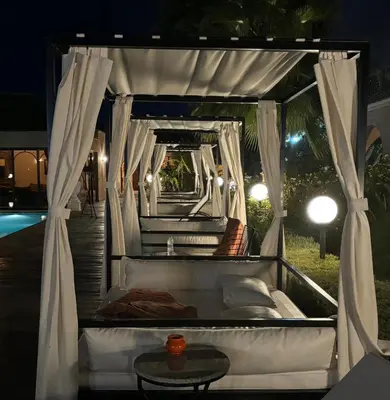 a white bed with a canopy and a table at Just V hotel & Spa in Marrakech
