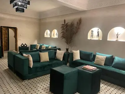 a living room with blue couches in a room at Just V hotel & Spa in Marrakech