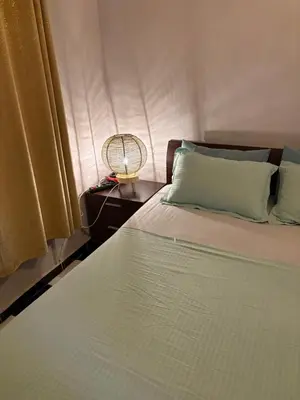 a bedroom with a bed with a fan and a window at Spacious Apartment with Motorcycle Garage, Free Parking, and Air Conditioning in Er Rachidia