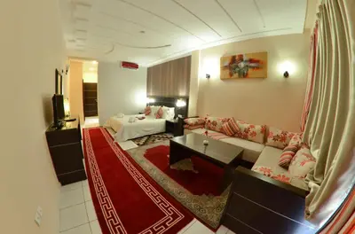 a living room with a couch and a table at Hotel Al Akha in Sidi Harazem