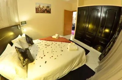 a bedroom with a bed with confetti on it at Hotel Al Akha in Sidi Harazem