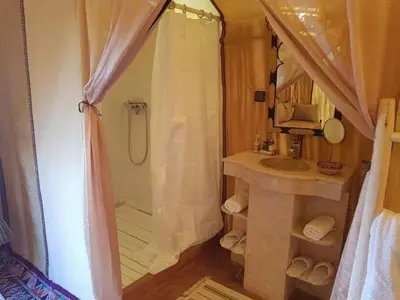 a bathroom with a shower and a sink at Africa Magic Camp in Merzouga