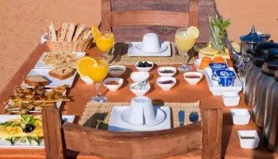 a table with food and drinks on it at Africa Magic Camp in Merzouga