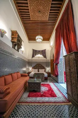 a living room with a couch and a bed at La Perle de La Medina in Fès