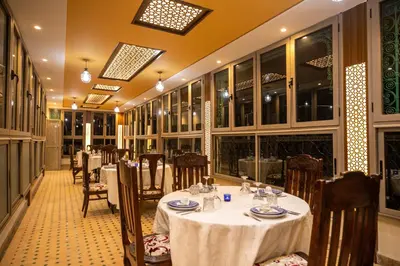 a restaurant with tables and chairs in a room at La Perle de La Medina in Fès