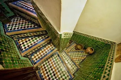 a set of stairs with different colored tiles on them at Dar Chourouk in Fès