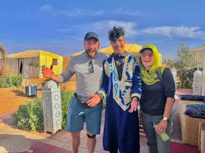 a group of three people posing for a picture at Guesthubcamp in Merzouga