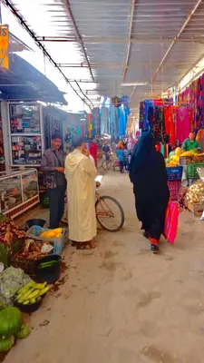 a group of people standing in a market at Guesthubcamp in Merzouga