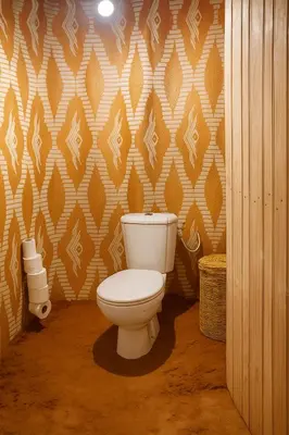 a bathroom with a white toilet in a room at Guesthubcamp in Merzouga