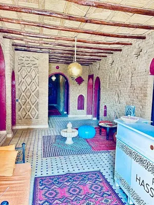 a room with a tile floor and a room with a table at Dar Hassi Labied Merzouga in Hassilabied